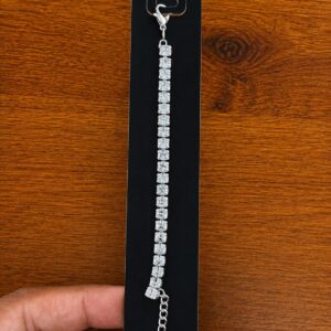 Tennis Bracelet in silver-tone style with a single line of square clear stone-like accents