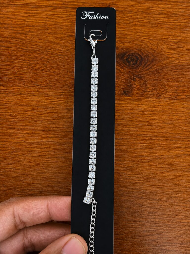 Tennis Bracelet in silver-tone style with a single line of square clear stone-like accents