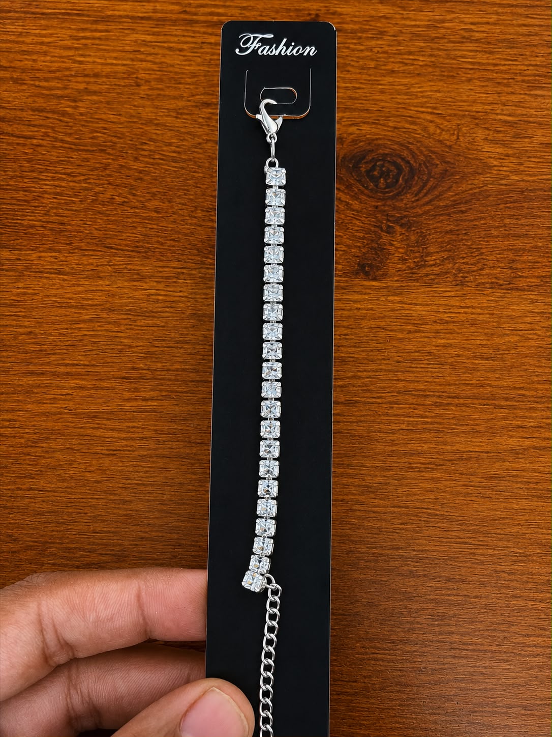Tennis Bracelet in silver-tone style with a single line of square clear stone-like accents