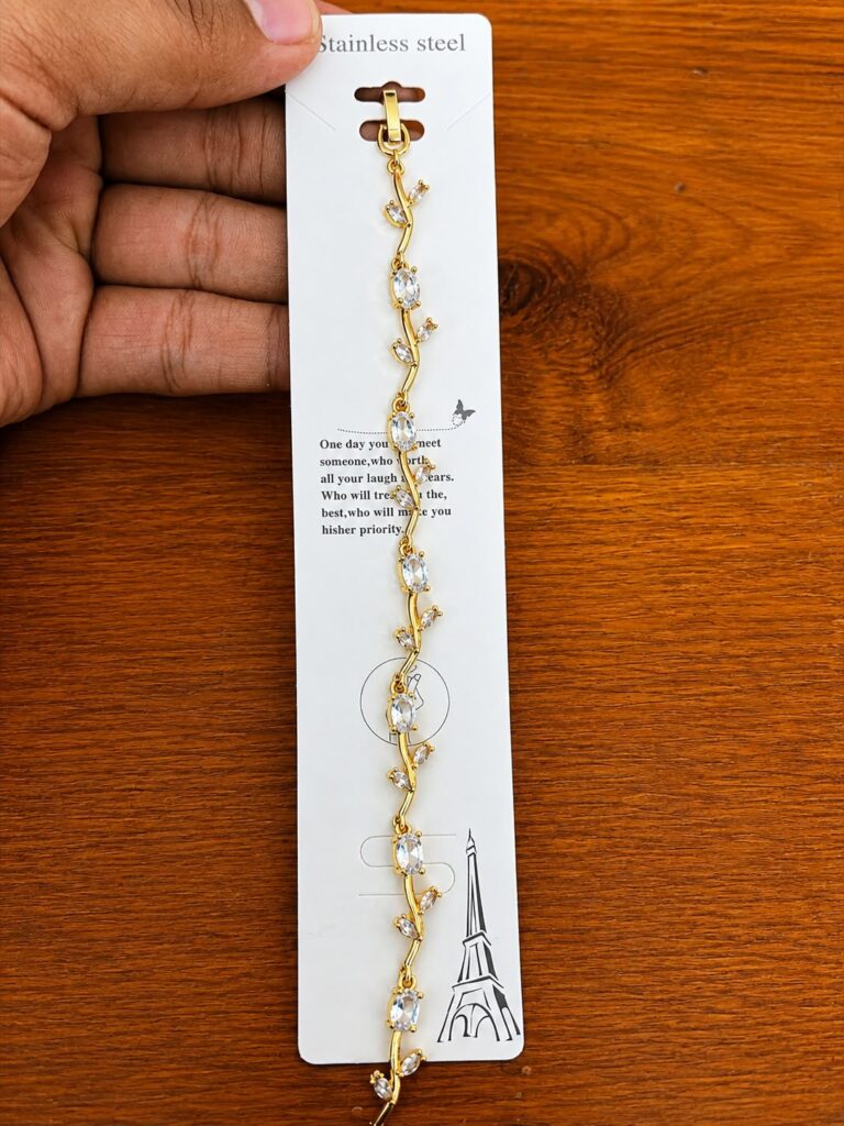 Clear Leaf Bracelet in gold-tone style with clear leaf-shaped accents arranged along a winding vine