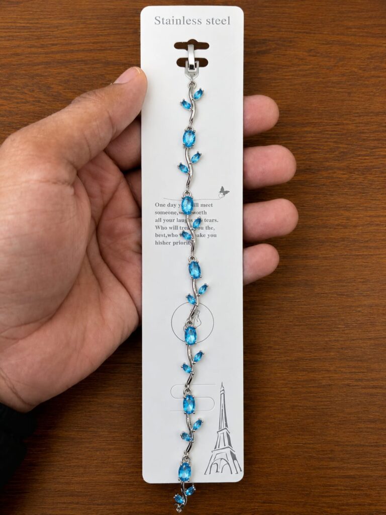 Blue Leaf Bracelet in silver-tone style with bright blue leaf-shaped accents arranged along a vine