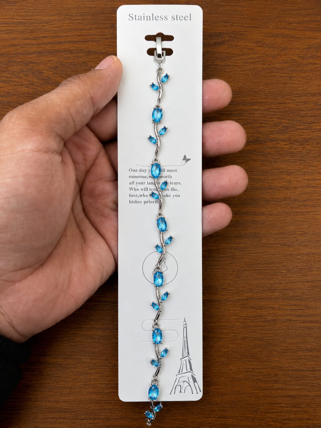Blue Leaf Bracelet in silver-tone style with bright blue leaf-shaped accents arranged along a vine