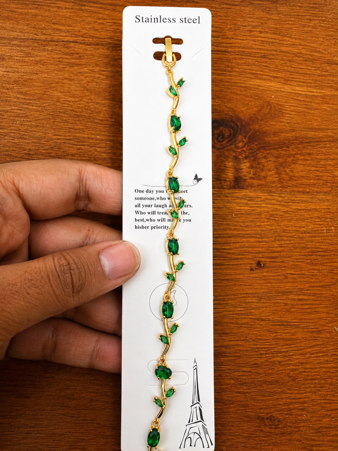 Green Vine Bracelet in gold-tone style with green leaf-shaped stations placed along a warm metallic vine