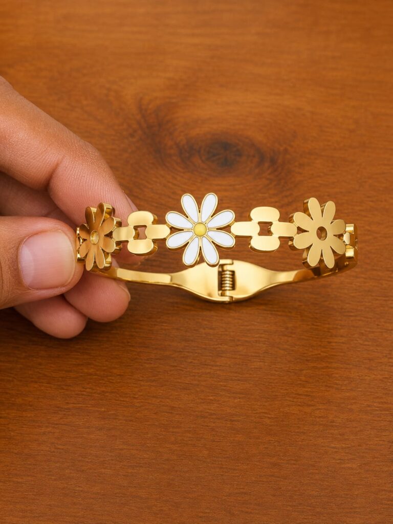 Daisy Cuff Bracelet in gold-tone style with white daisy motifs across an open hinged cuff
