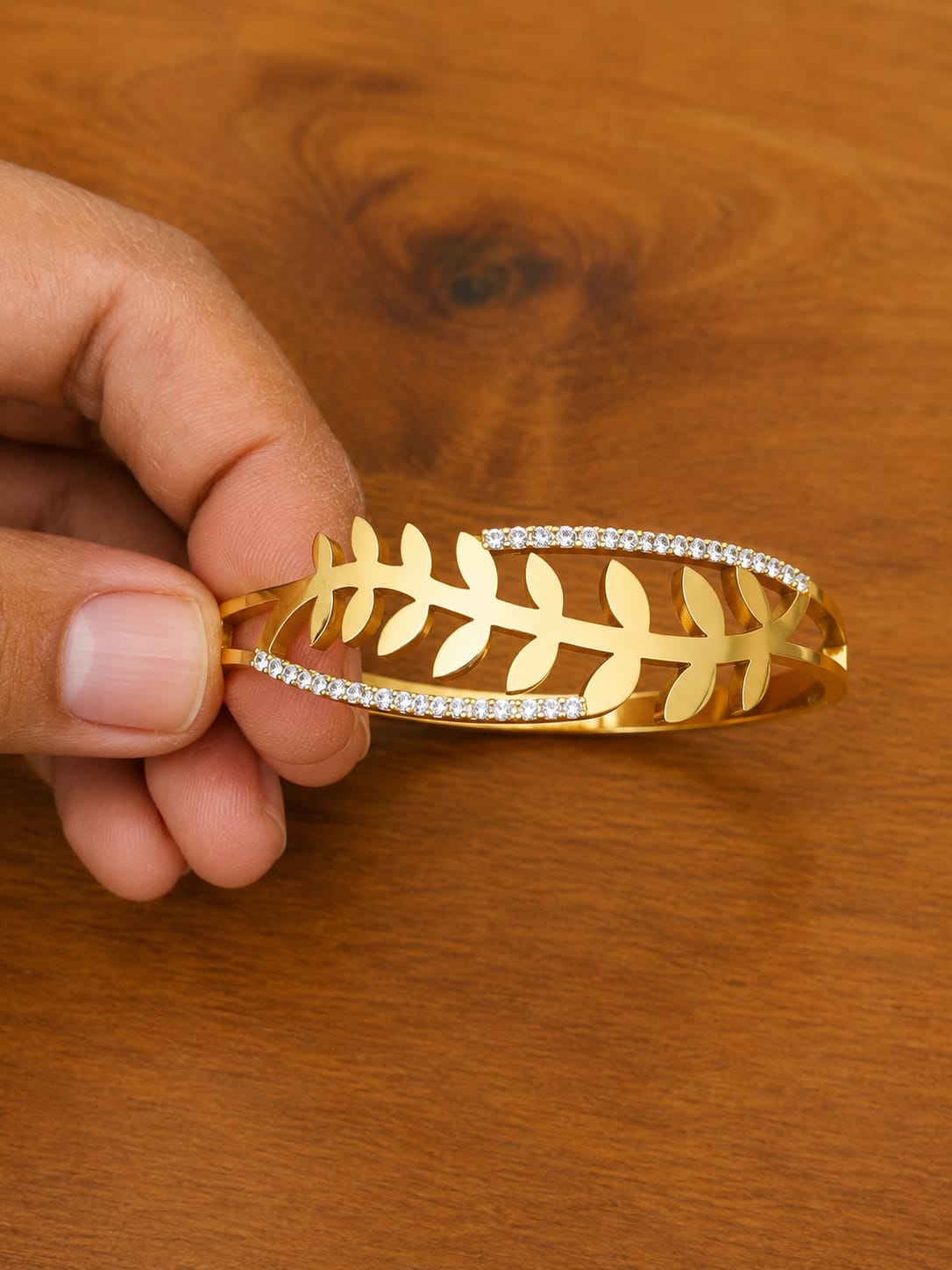 Leaf Cuff Bracelet in gold-tone style with an open leaf branch framed by rows of clear accents