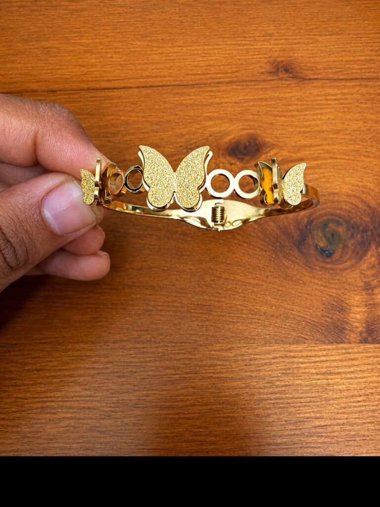 Openwork Butterfly Cuff Bracelet in gold-tone style with a textured butterfly centre between circular openwork details