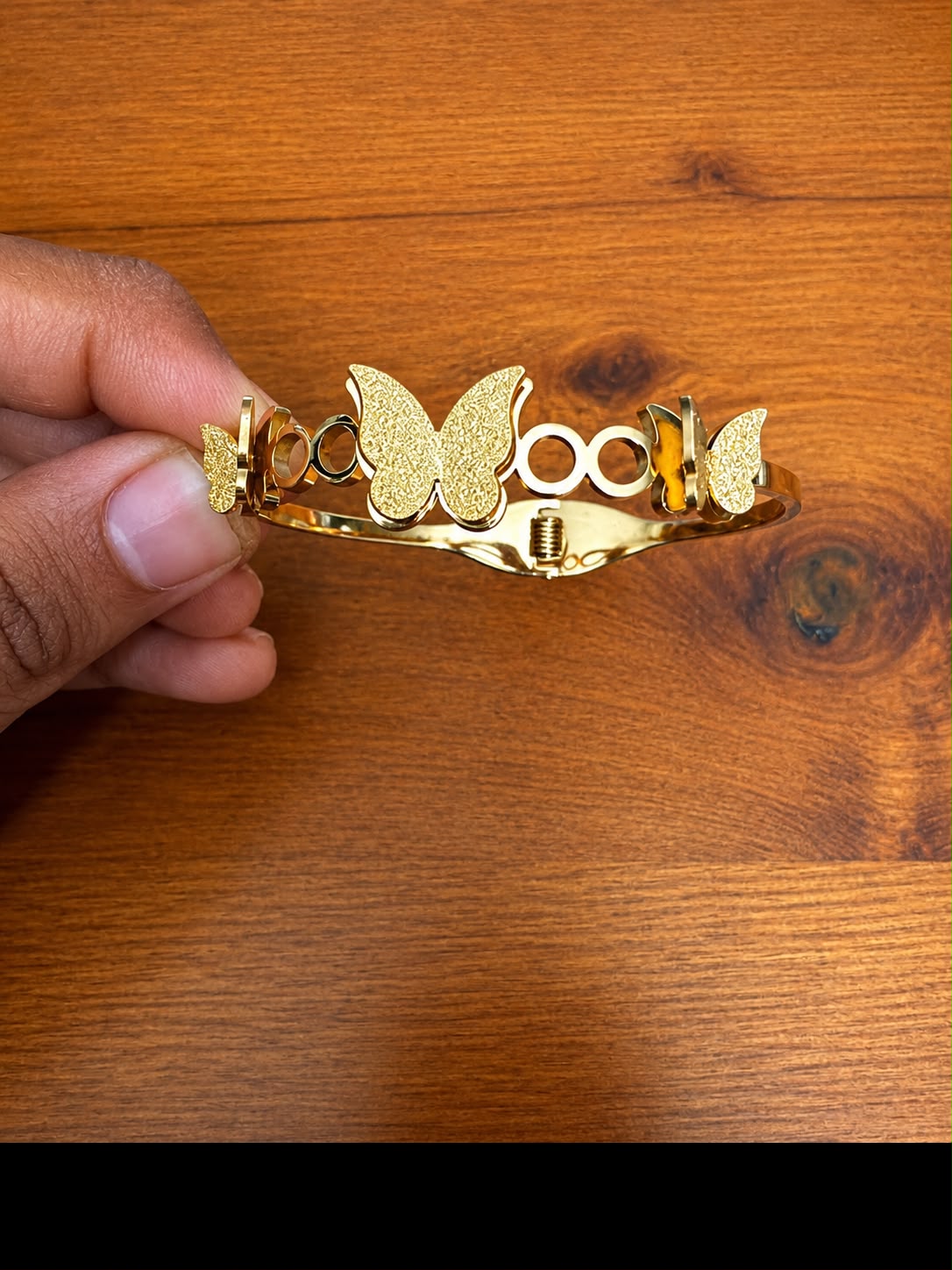 Openwork Butterfly Cuff Bracelet in gold-tone style with a textured butterfly centre between circular openwork details