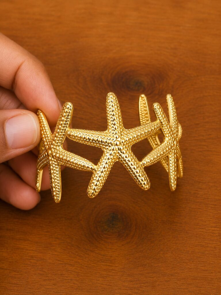 Starfish Cuff Bracelet in gold-tone style with overlapping textured starfish motifs across an open cuff