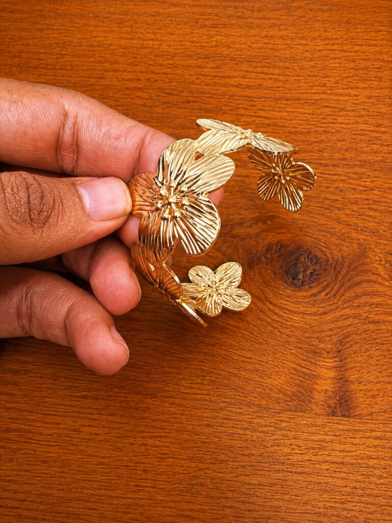 Floral Cuff Bracelet in gold-tone style with layered flower and leaf motifs with etched texture