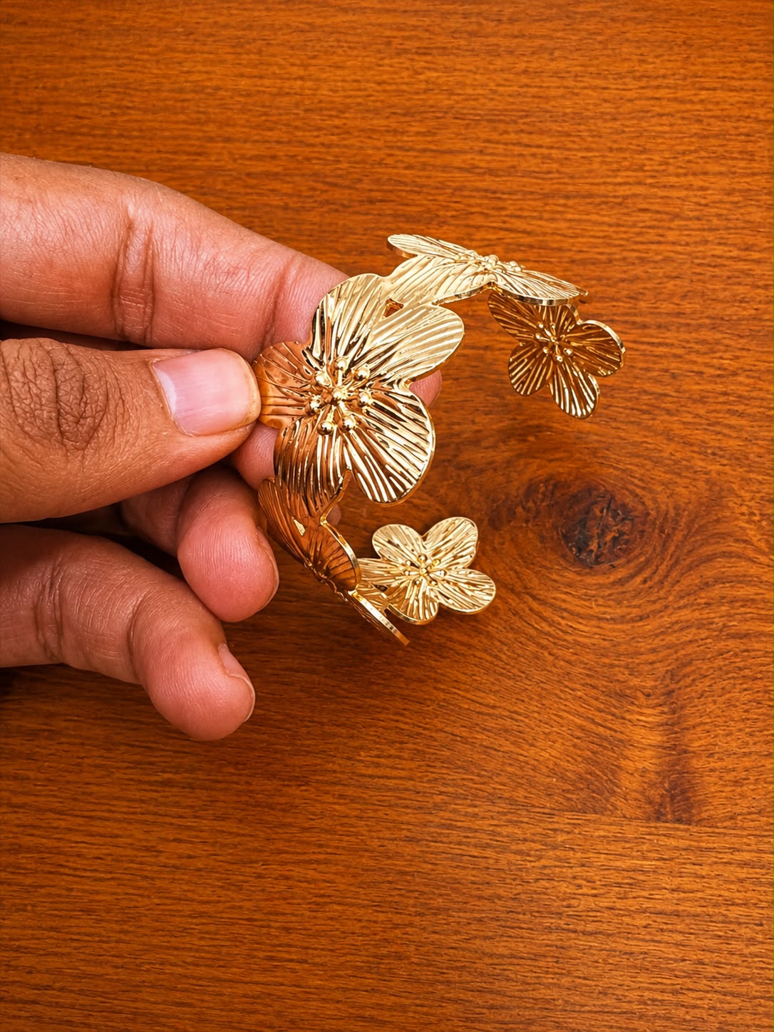 Floral Cuff Bracelet in gold-tone style with layered flower and leaf motifs with etched texture