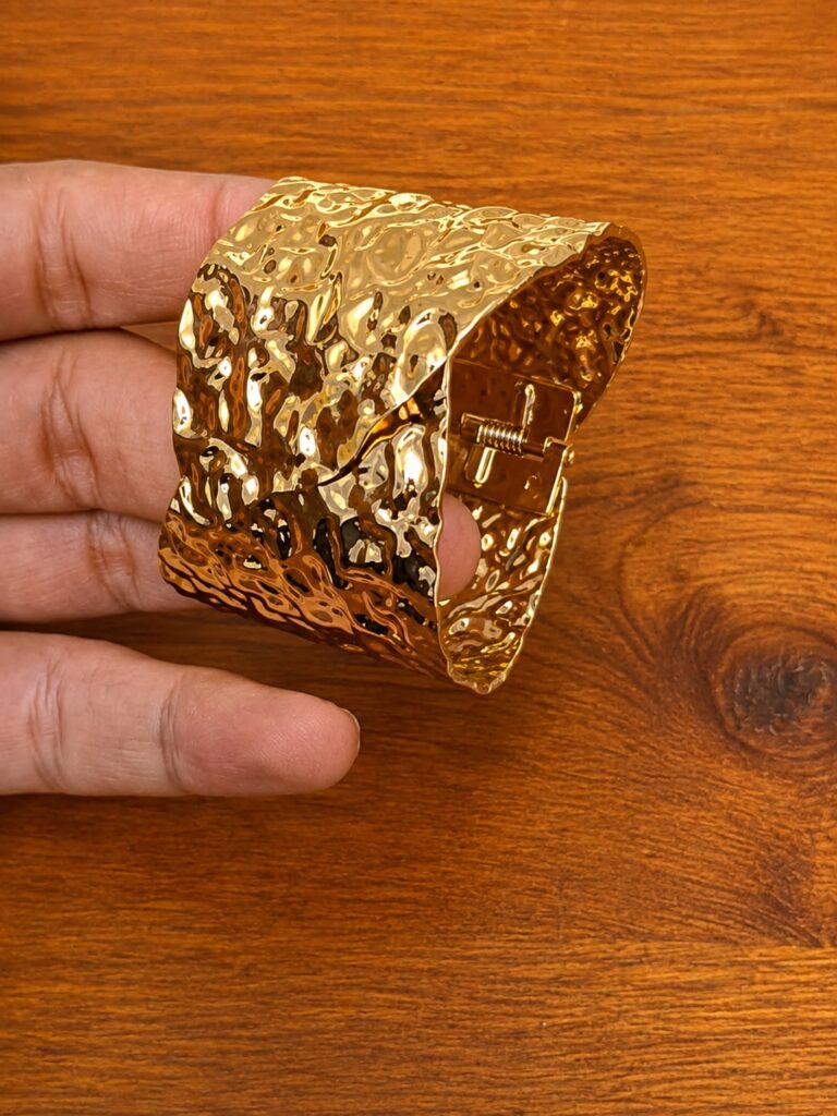 Textured Wide Cuff Bracelet in gold-tone style with a broad openwork cuff with irregular hammered texture