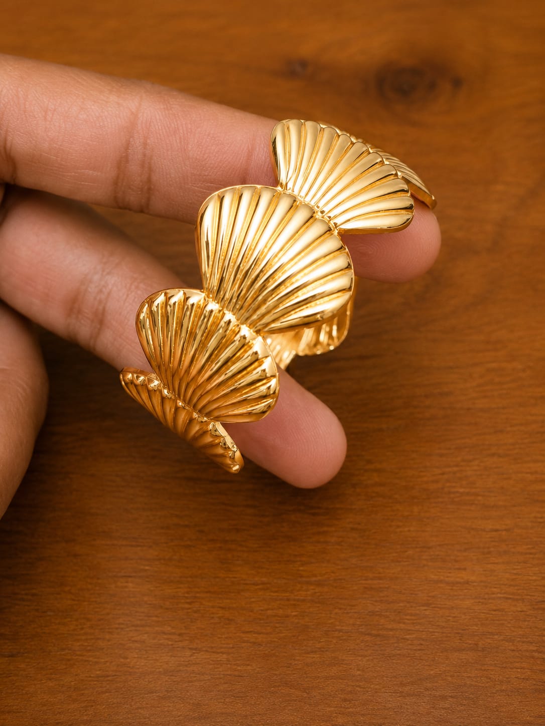 Shell Cuff Bracelet in gold-tone style with overlapping scallop-shell motifs with radiating grooves