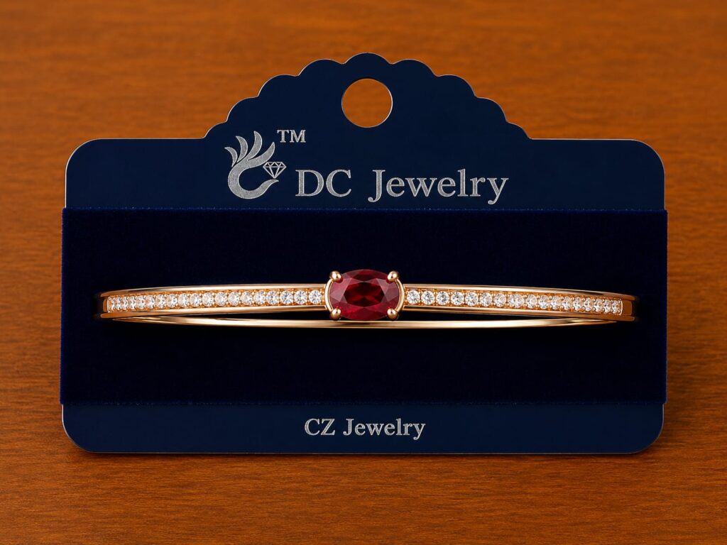 Red Stone Bar Bracelet in gold-tone style with a red oval centre on a slim clear-accent bar