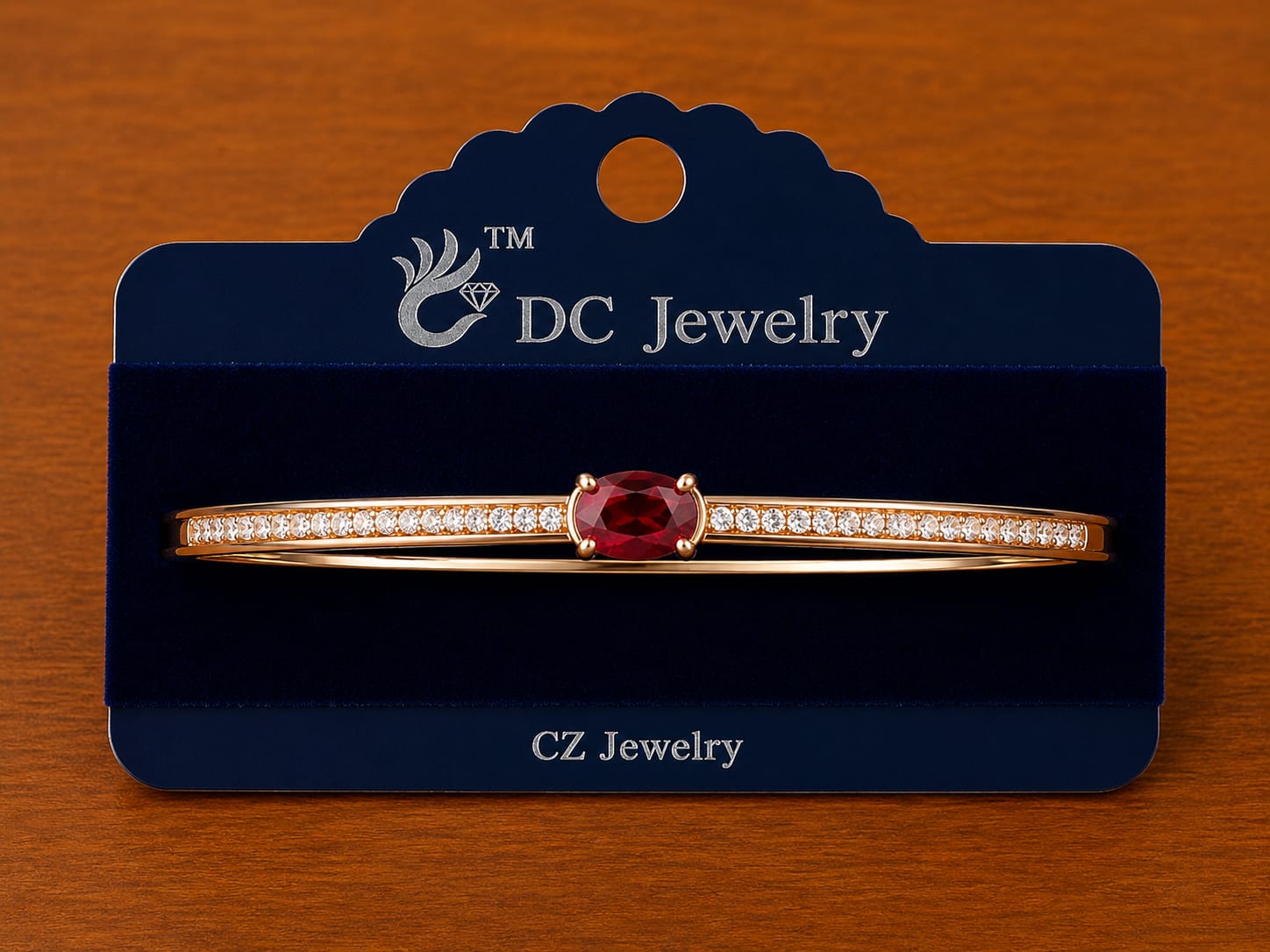Red Stone Bar Bracelet in gold-tone style with a red oval centre on a slim clear-accent bar