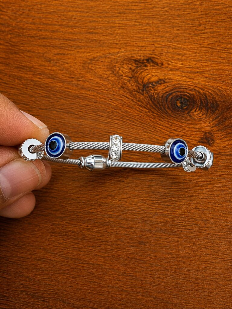 Evil Eye Cable Bracelet in silver-tone style with blue eye motifs at both ends of a cable-style bracelet