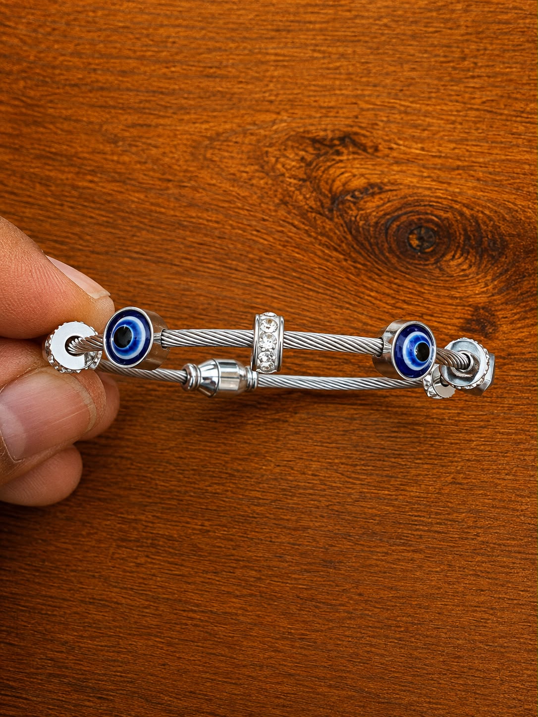 Evil Eye Cable Bracelet in silver-tone style with blue eye motifs at both ends of a cable-style bracelet