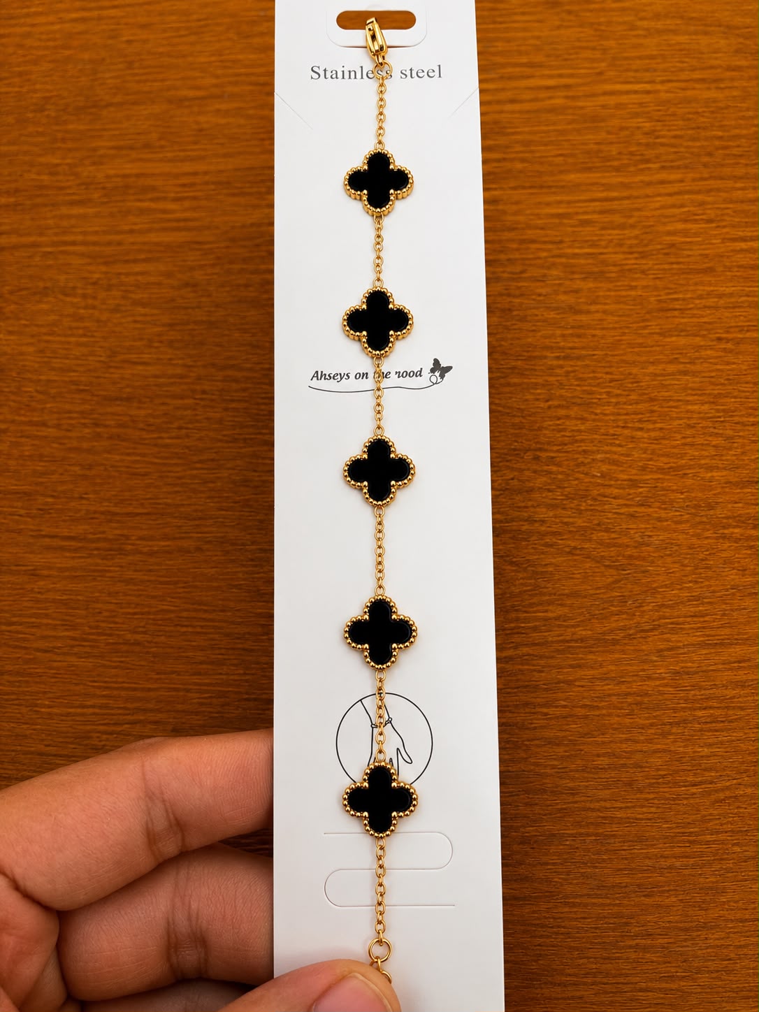Black Clover Station Bracelet in gold-tone style with five black clover stations spaced along a fine chain