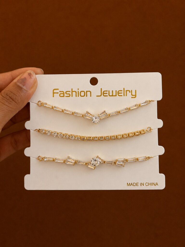 Set of 3 Geometric Chain Bracelets in gold-tone style with three fine bracelets with diamond and bar-shaped accents
