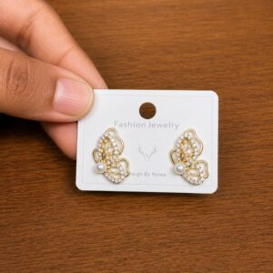 Pearl Butterfly Stud Earrings in gold-tone style with butterfly outlines filled with pearl-like and clear accents