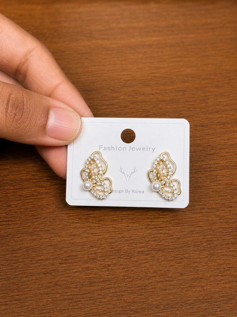 Pearl Butterfly Stud Earrings in gold-tone style with butterfly outlines filled with pearl-like and clear accents