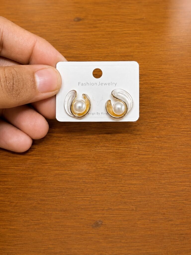 Pearl Swirl Stud Earrings in gold-tone style with curved swirl frames around pearl-like centres
