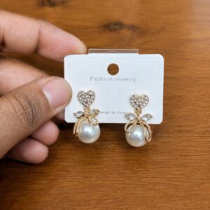 Bow Pearl Drop Earrings in silver-tone style with clear bow-shaped tops with large pearl-like drops