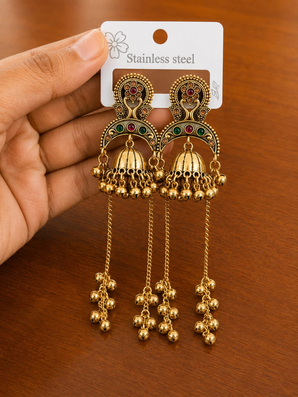 Peacock Jhumka Tassel Earrings in antique gold-tone style with peacock-inspired arches, domes and long bead tassels