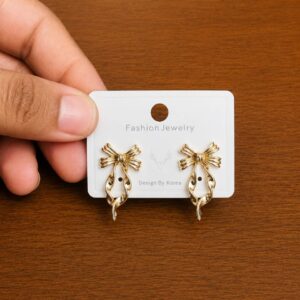 Striped Bow Pearl Stud Earrings in gold-tone style with striped bow motifs above pearl-like drops