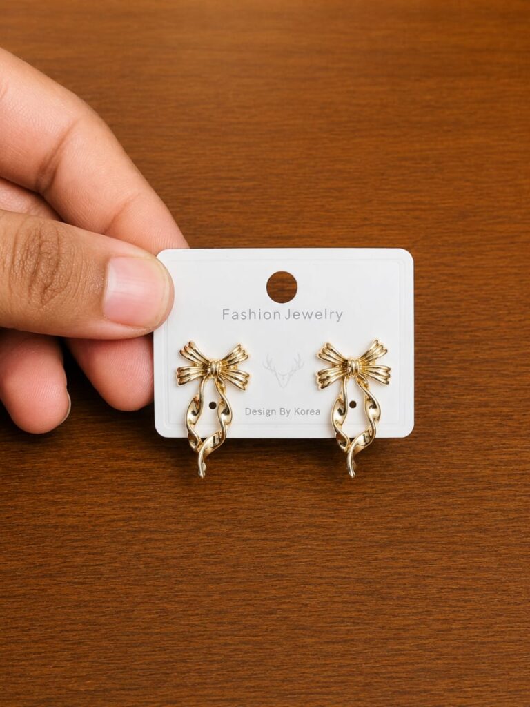 Striped Bow Pearl Stud Earrings in gold-tone style with striped bow motifs above pearl-like drops