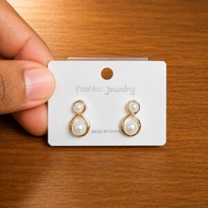 Figure Eight Pearl Stud Earrings in gold-tone style with open figure-eight frames with pearl-like centres