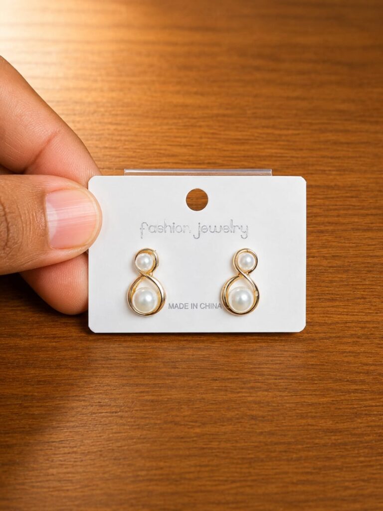 Figure Eight Pearl Stud Earrings in gold-tone style with open figure-eight frames with pearl-like centres