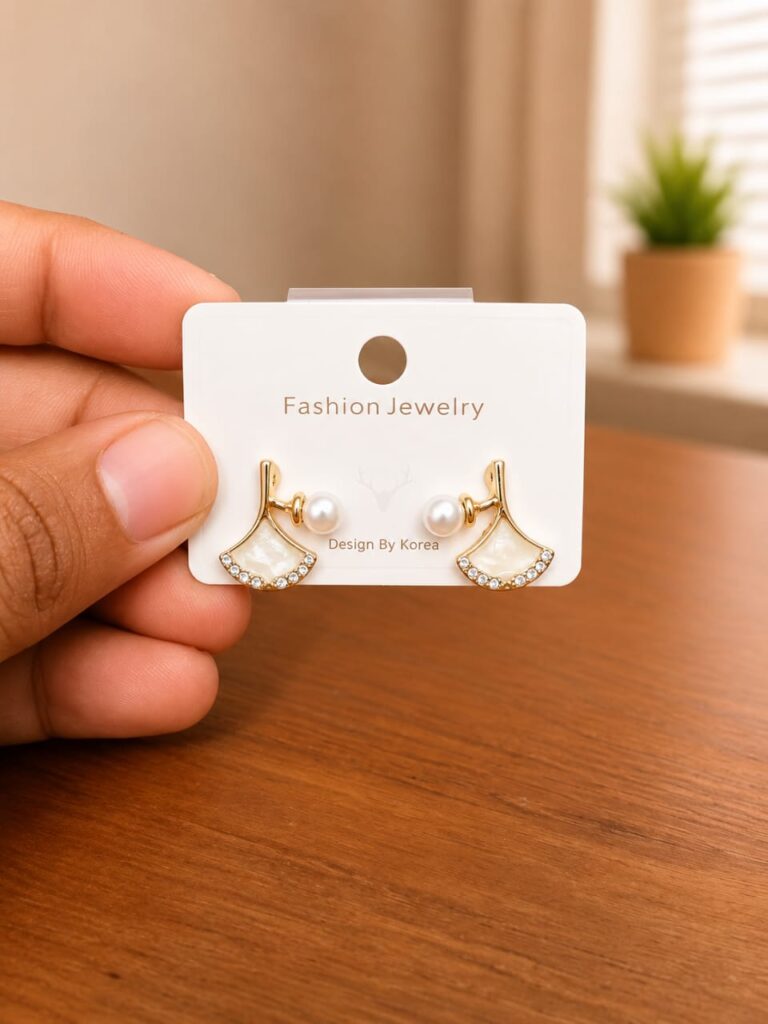 Bell Stud Earrings in gold-tone style with small white bell-shaped motifs with clear borders