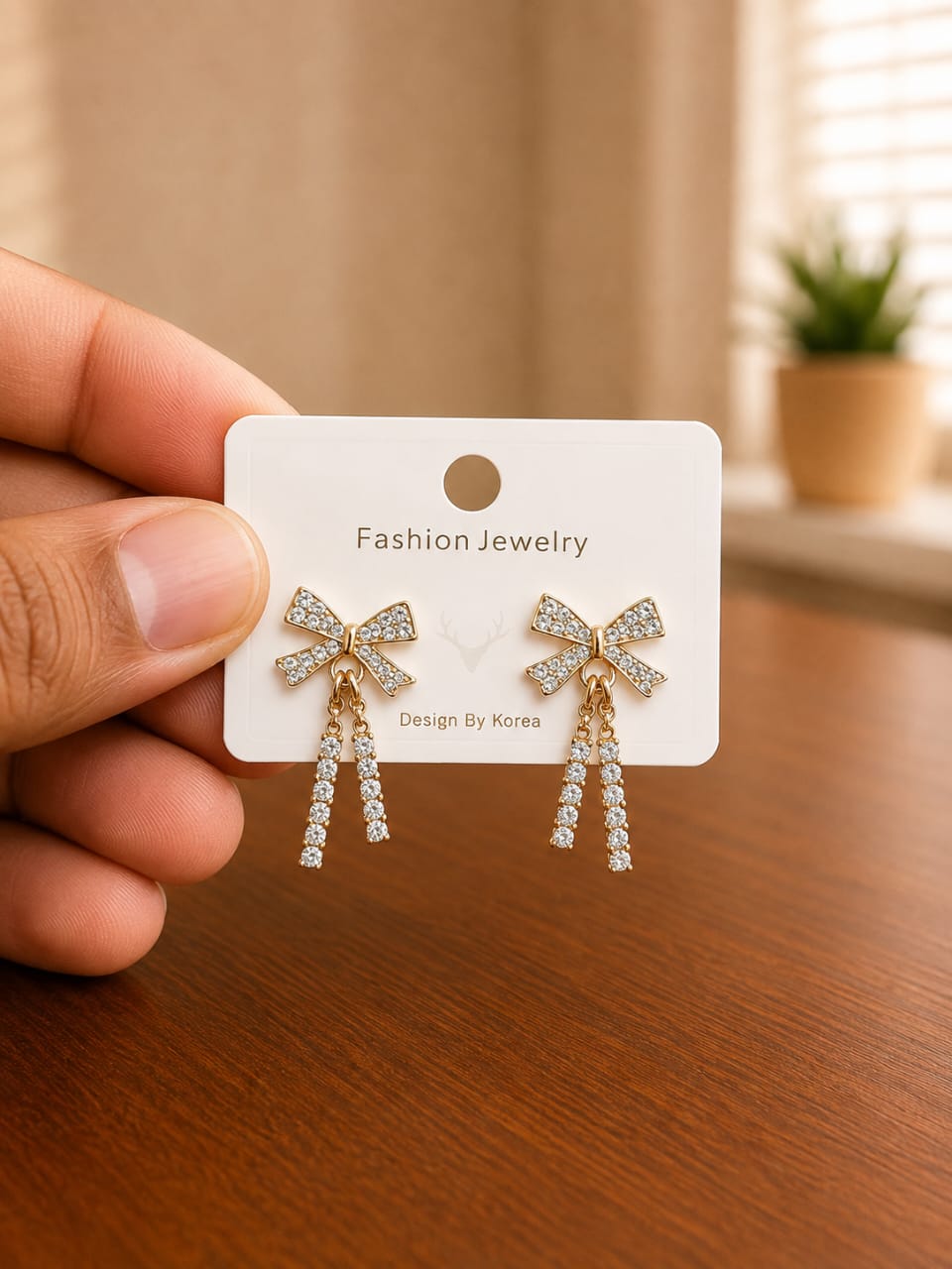 Bow Chain Drop Earrings in gold-tone style with clear bow tops with two fine hanging chains