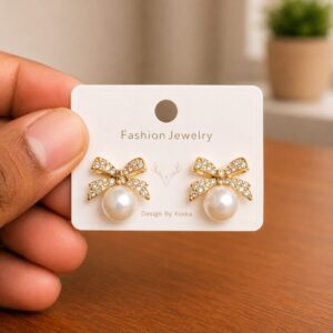 Clear Bow Pearl Stud Earrings in gold-tone style with clear bow motifs set above pearl-like centres