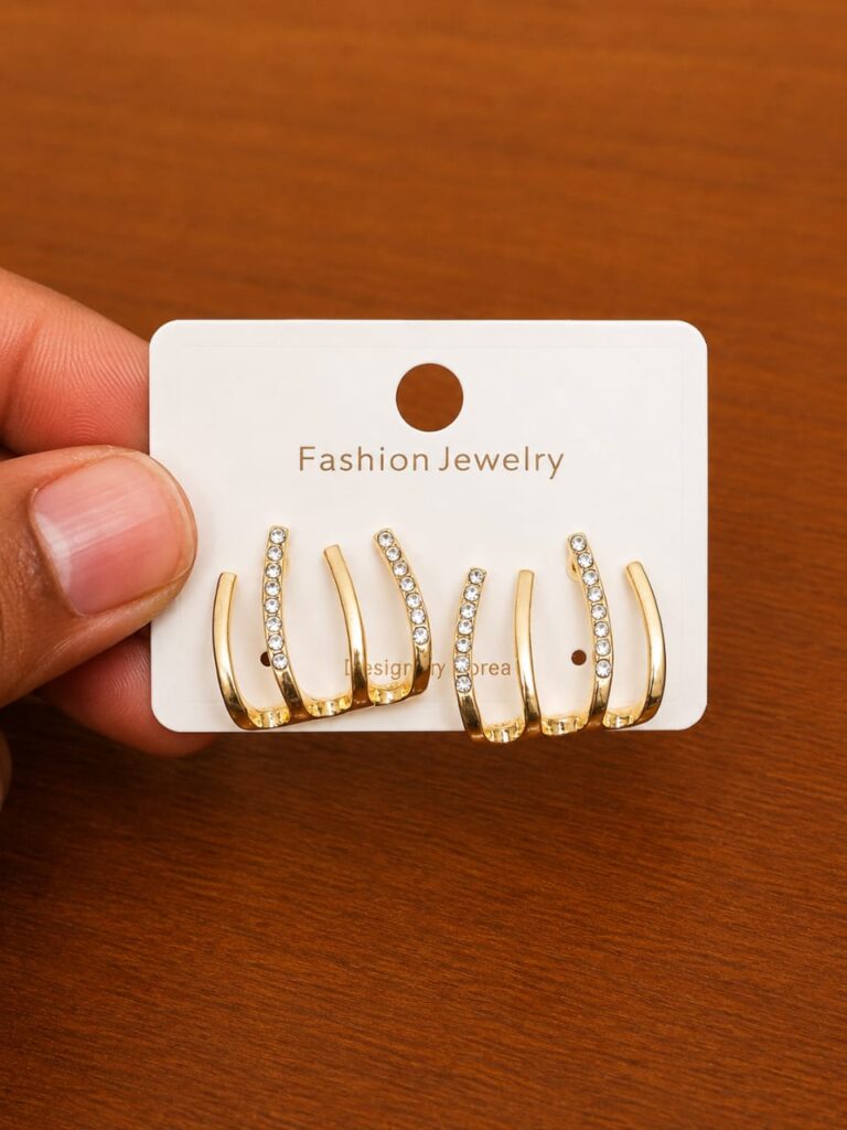 Triple Hoop Stud Earrings in gold-tone style with three graduated curved bars with clear inner rows