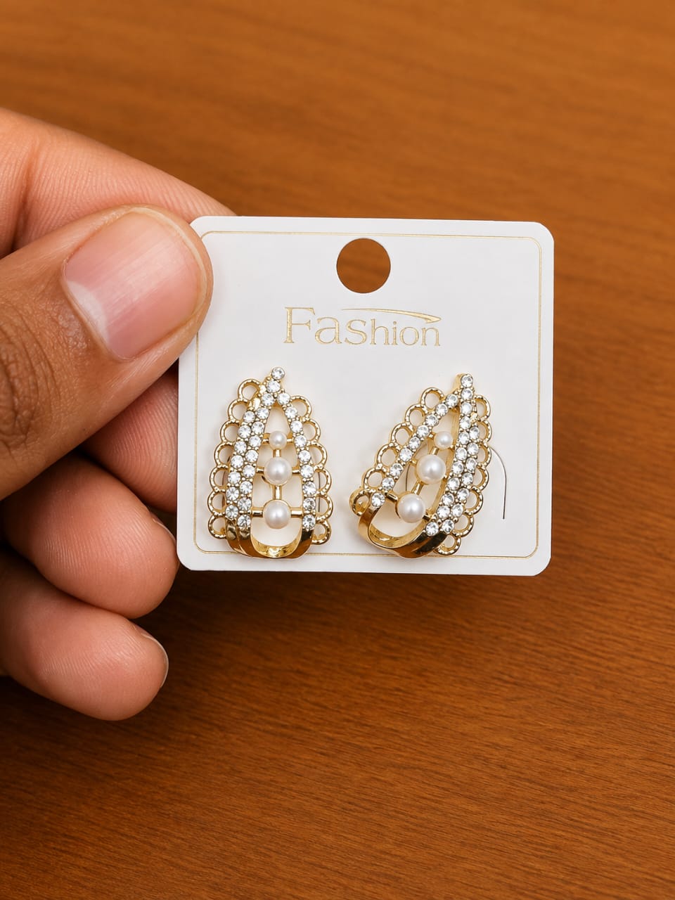 Clear Frame Pearl Oval Stud Earrings in gold-tone style with oval frames filled with pearl-like and clear accents
