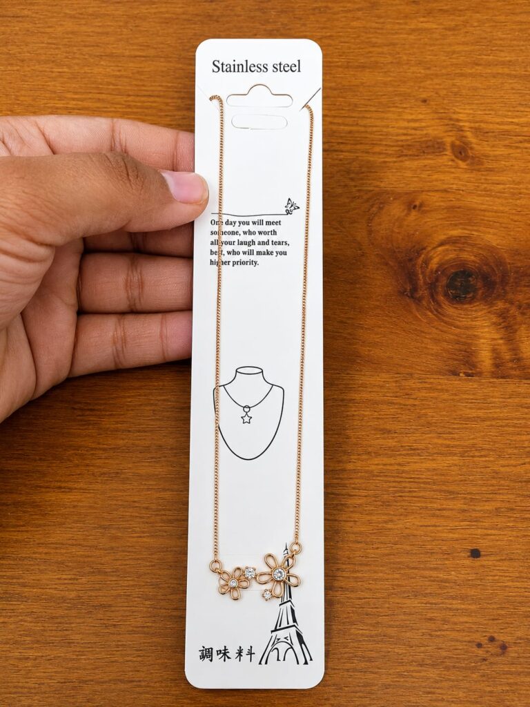 Rose gold-tone necklace with two open flower pendants and clear stones