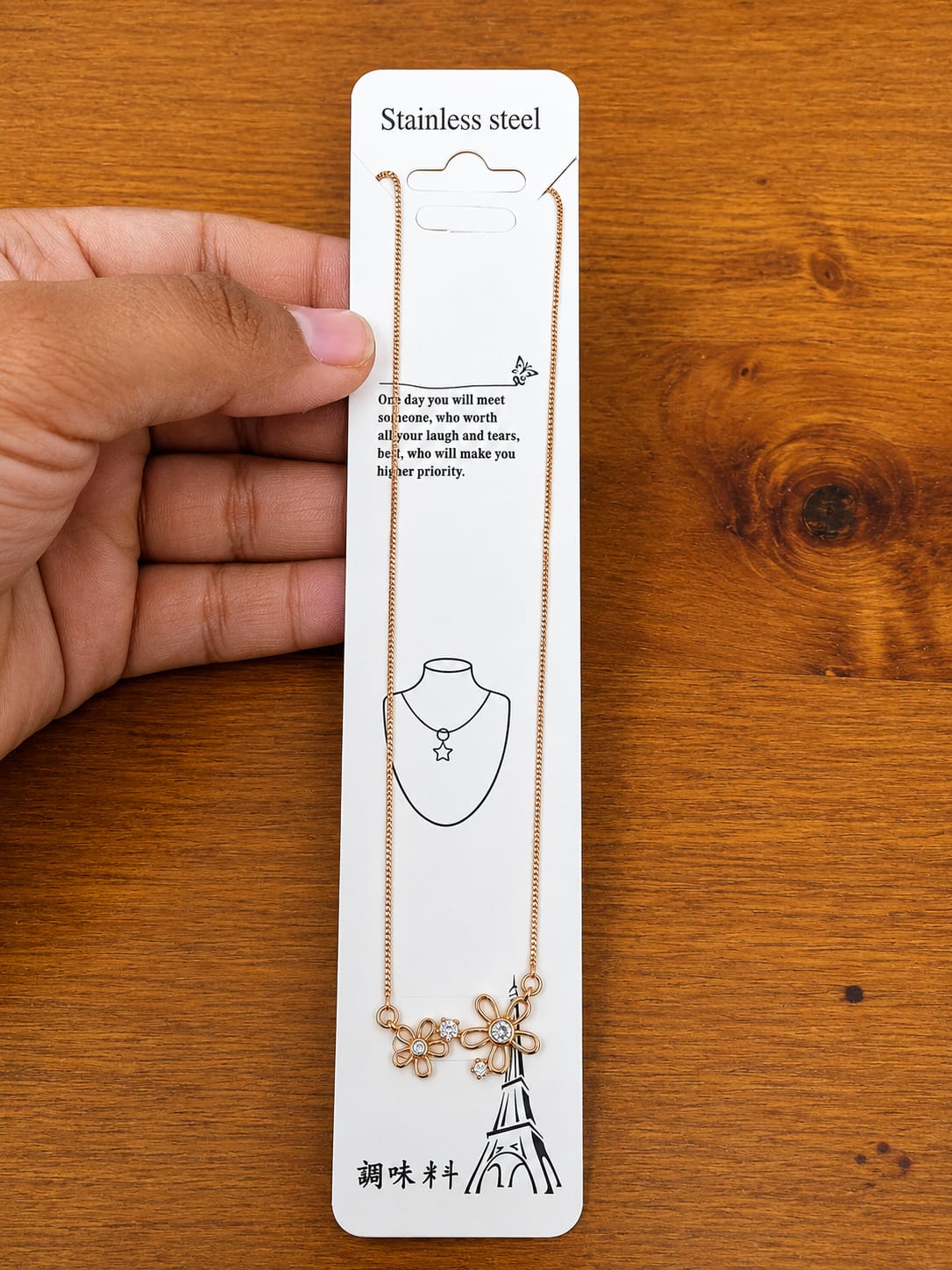 Rose gold-tone necklace with two open flower pendants and clear stones