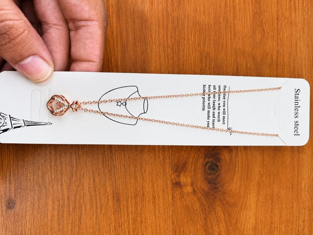 Rose gold-tone crown pendant necklace with clear stone accents