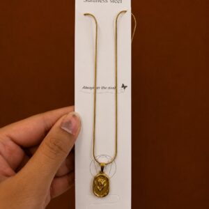 Gold-tone tulip necklace with an embossed oval medallion