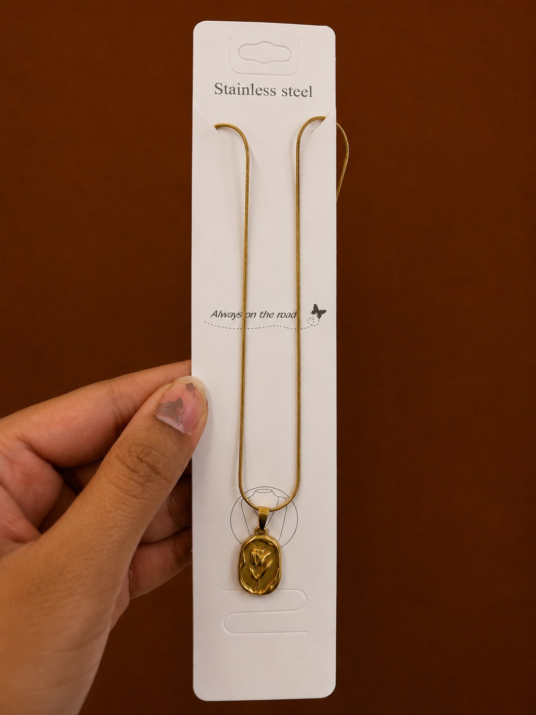 Gold-tone tulip necklace with an embossed oval medallion