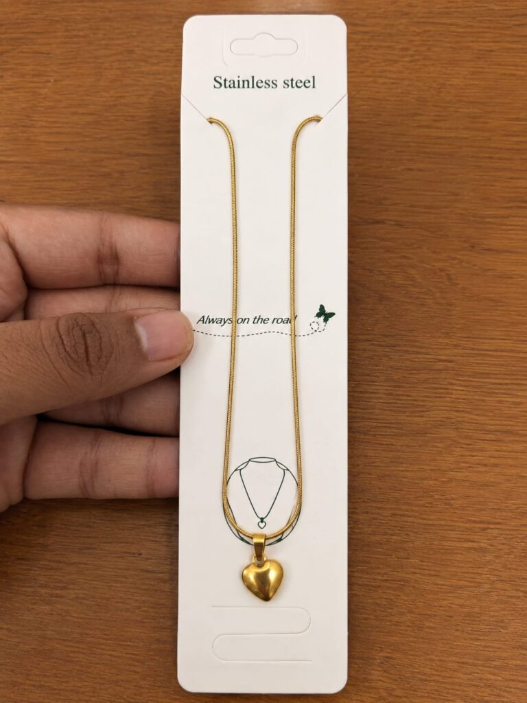 Gold-tone necklace with a small polished puffy heart pendant