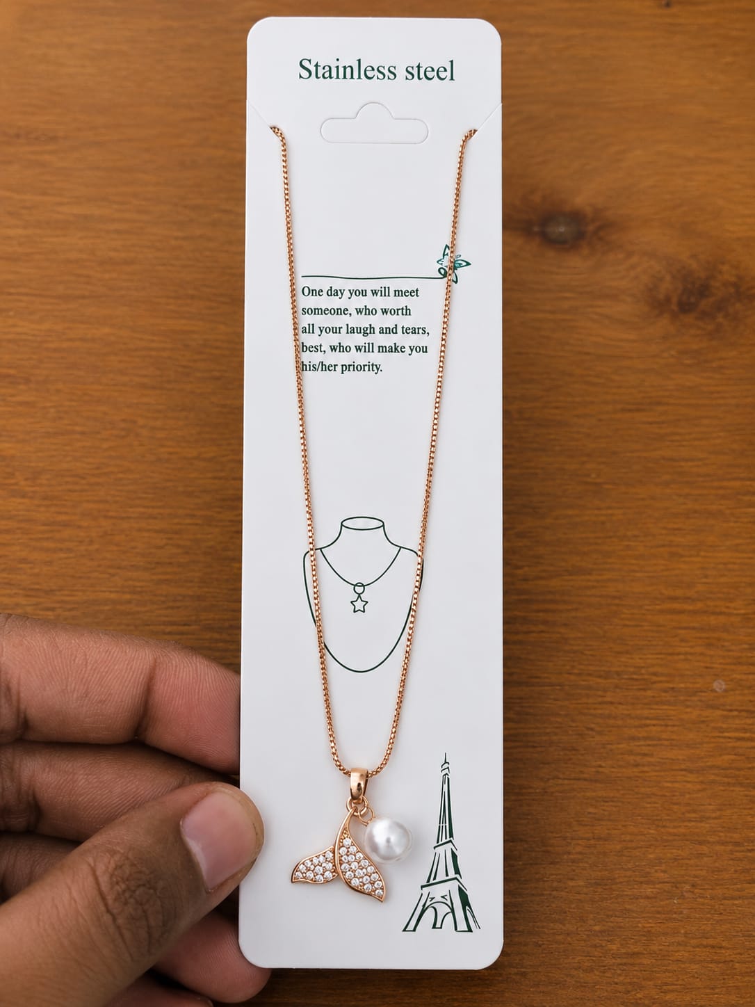 Rose gold-tone mermaid tail necklace with clear stones and a pearl-like drop
