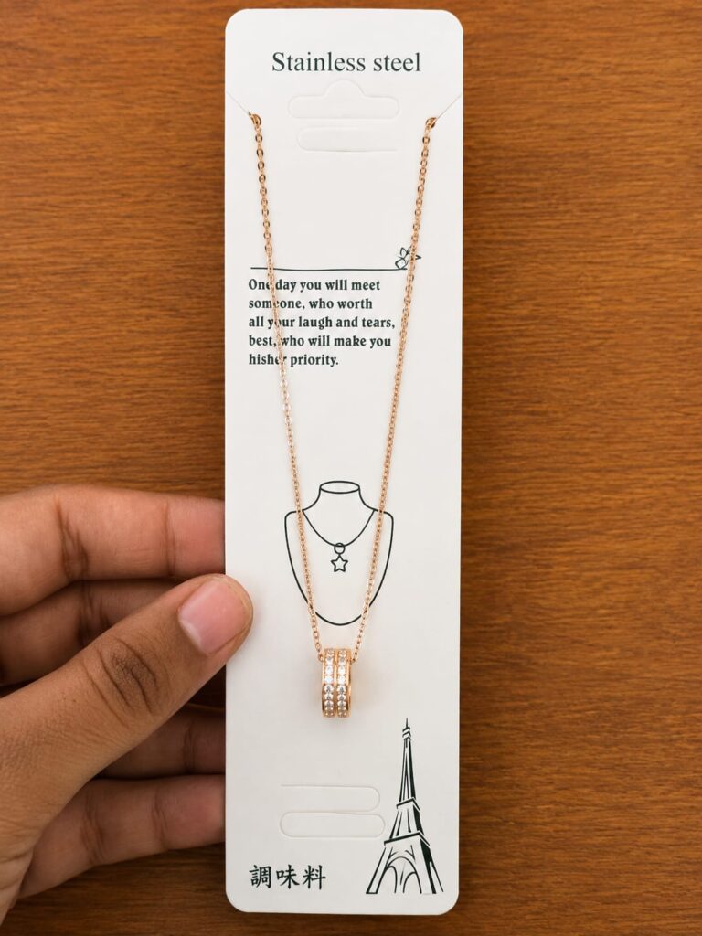 Rose gold-tone three-ring pendant necklace with clear stone accents