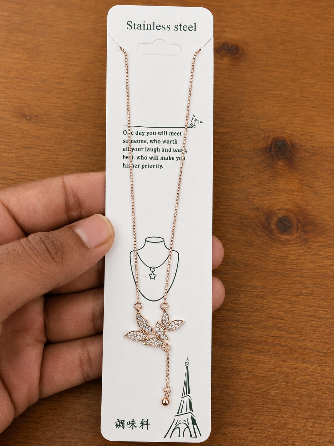 Rose gold-tone leaf pendant necklace with clear stones and a tassel